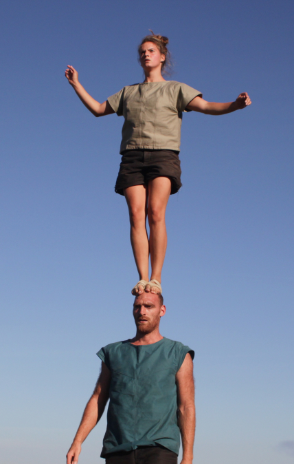 Girl standing on a guy's head