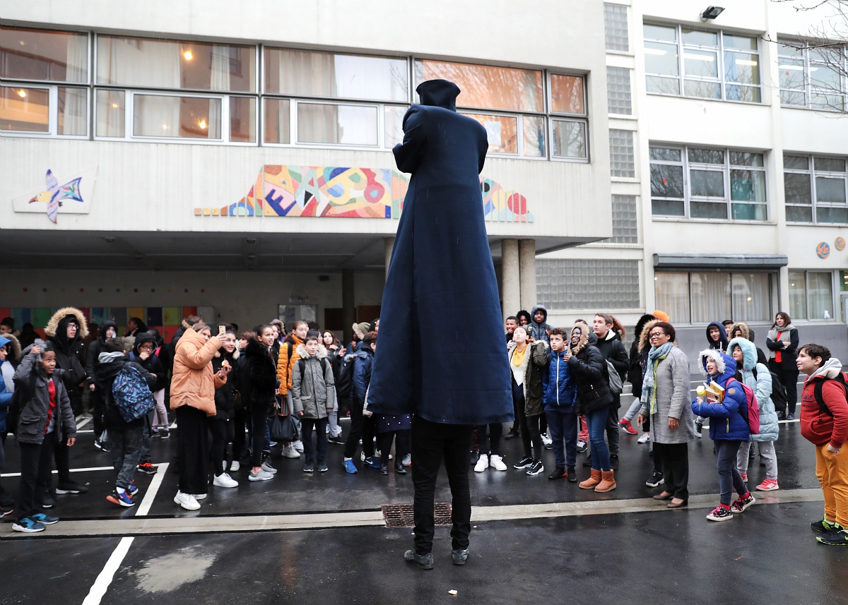 Giant performing in front of kids