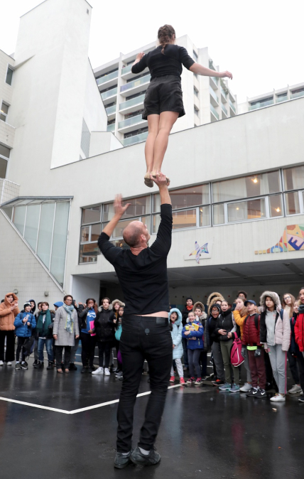 Girl and a guy performing acrobatics